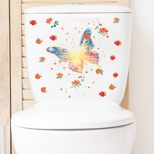 Detailed view of luminous butterfly and rose stickers applied on a white toilet tank