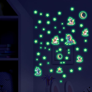 Glow-in-the-dark unicorn and stars wall stickers shining in a dark kid's bedroom setting