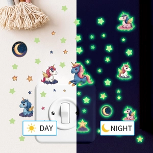 Luminous unicorn wall decals showing day and night glow effect on kids room wall