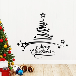 Detail of black Merry Christmas wall sticker with tree and stars in a cozy home setting