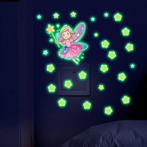 Luminous wall stickers with fairy and stars glowing around a light switch in the dark