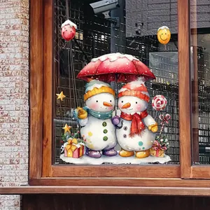Detailed Christmas window sticker showing snowmen under a red umbrella on glass