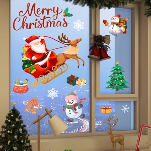 Detail showing Santa Claus sleigh and snowman static window decals on glass surface