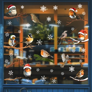 Detail of Christmas window stickers featuring realistic birds with red hats and white snowflakes
