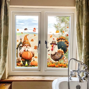 Close-up of Thanksgiving window clings with gnomes and pumpkins on a home window glass
