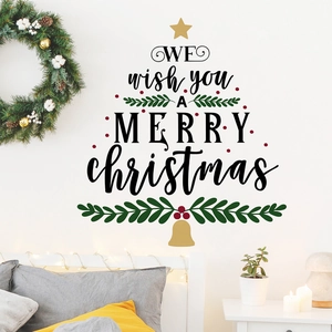 Detail of Christmas tree wall sticker with festive English lettering on white bedroom wall
