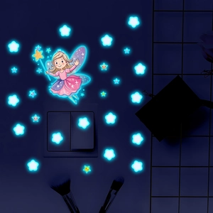 Luminous wall stickers with a fairy and stars glowing in ice blue light on a wall switch