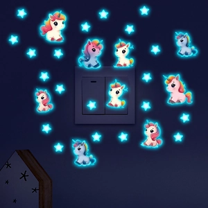 Luminous unicorn and stars wall stickers glowing in blue against a dark wall background