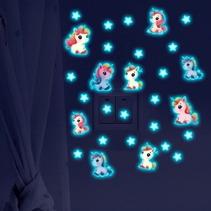 Luminous unicorn and stars wall stickers glowing in the dark around a light switch