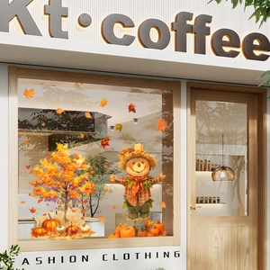 Detail view of Thanksgiving window decals featuring maple tree, scarecrow and pumpkins