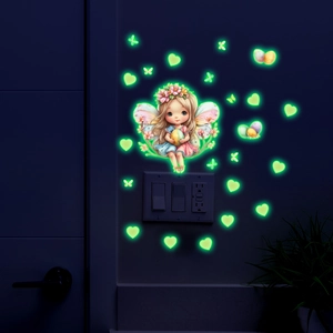 Glow in the dark fairy and butterfly wall stickers illuminating a room at night