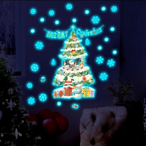 Close-up of luminous Christmas tree wall decals glowing in dark blue light