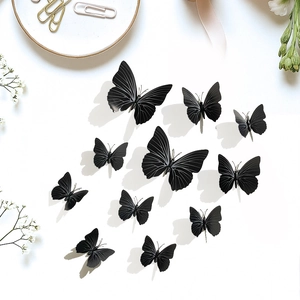 Set of 12 black 3D butterfly wall stickers with realistic wings on minimalist background