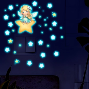 Glow in the dark fairy on star wall sticker set illuminating a light switch at night