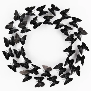 Set of 24 black 3D butterfly wall stickers with white stripes in a circular arrangement