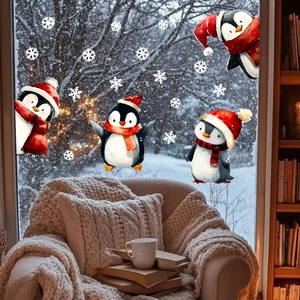 Cozy home window decorated with cute watercolor penguin stickers and white snowflakes