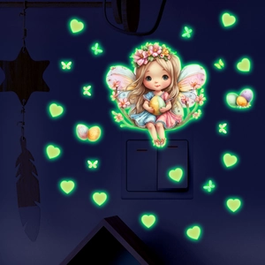 Luminous wall sticker showing a fairy and glowing hearts above a light switch in the dark