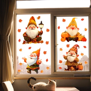 Detail of autumn gnome window clings with maple leaves and cat in a cozy room