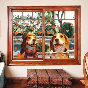 Detail view of cute beagle puppy stickers with orange autumn maple leaves on window glass