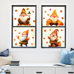 Detailed view of autumn gnome window clings featuring maple leaves and pumpkins on glass