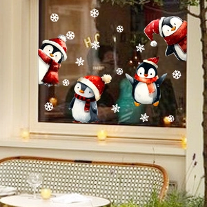 Christmas window stickers featuring watercolor penguins and snowflakes on glass background