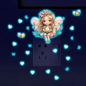 Glow in the dark fairy and butterfly wall stickers applied around a power socket
