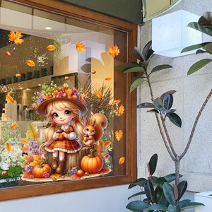 Close-up of fall-themed window decals with girl, squirrel, and pumpkins on glass