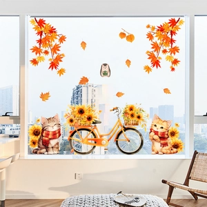 Détail de stickers fenêtre automne avec deux chats sur un vélo et des feuilles d'érable