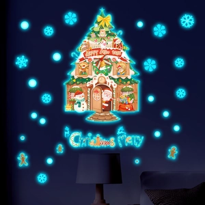 Glow-in-the-dark Christmas tree wall decal with festive snowflake and gingerbread motifs