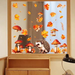 Detail of autumn window stickers featuring a cute hedgehog, maple leaves and mushrooms