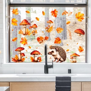 Detail view of autumn window stickers with hedgehog, maple leaves and mushrooms in kitchen