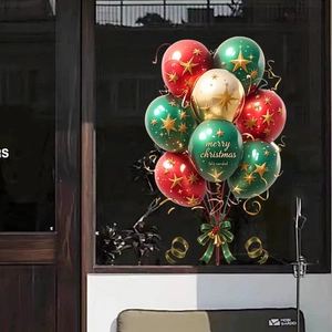 Close-up of Christmas balloons with Merry Christmas text and gold star patterns on glass