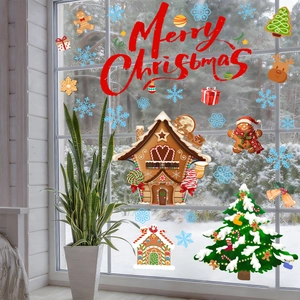 Detail of Christmas window clings featuring a gingerbread house and Merry Christmas text