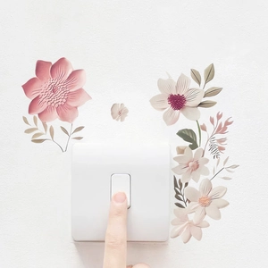 Detailed view of floral wall stickers with pink and yellow blossoms around a wall switch