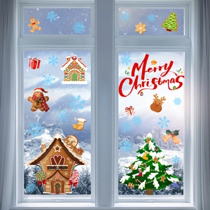 Close-up of Christmas window stickers featuring gingerbread house and festive tree
