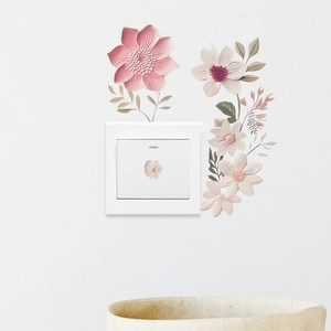 Detailed view of floral wall stickers applied around a light switch for home decoration