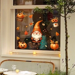 Detail of Thanksgiving gnome stickers with pumpkins and maple leaves on window glass