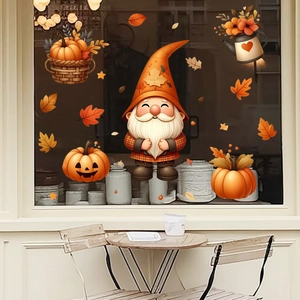 Detail of Thanksgiving window decals featuring a gnome with pumpkins and fall maple leaves