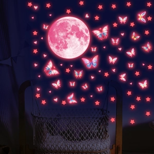 Luminous wall stickers featuring a pink moon and glowing butterflies in a nursery setting