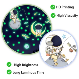 Glow-in-the-dark astronaut and stars wall decals showing day and night luminous contrast effect