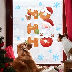 Cozy Christmas setting with HO HO HO window stickers and pets looking at a festive tree