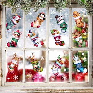 Close-up of colorful Christmas sock window stickers on glass with snowy background scenery