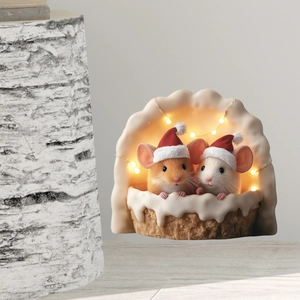 Detail of Christmas mouse miniature with glowing LED lights in a cozy snow nest