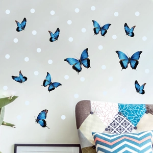 Luminous blue butterfly and white dot wall stickers applied on a modern grey home wall