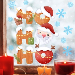 Detail of HO HO HO Christmas window stickers with Santa Claus and snowflakes motifs