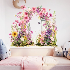Detail showing floral wreath wall sticker with butterflies and soft pink daisies on nursery wall