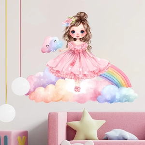 Detail view of cartoon girl and rainbow wall stickers in a cozy pink nursery setting