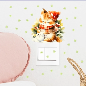 Detail of cute cat with red scarf wall sticker and snowflake decals on white wall