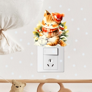 Close-up of a cute orange cat wall sticker wearing a red hat and scarf on a white wall