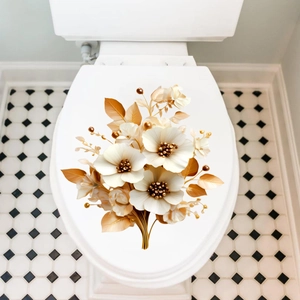 Detailed view of elegant gold and cream floral stickers applied on a white toilet lid cover